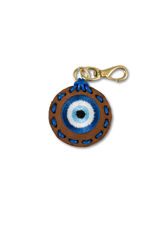 Wild Thread Studio suede leather Evil Eye charm with blue embroidered eye and hand-stitched border and solid brass hardware